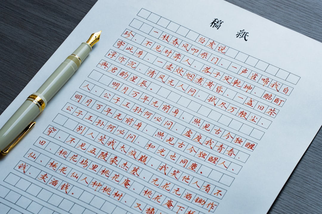 A fountain pen resting on a sheet of manuscript paper with handwritten Chinese calligraphy.